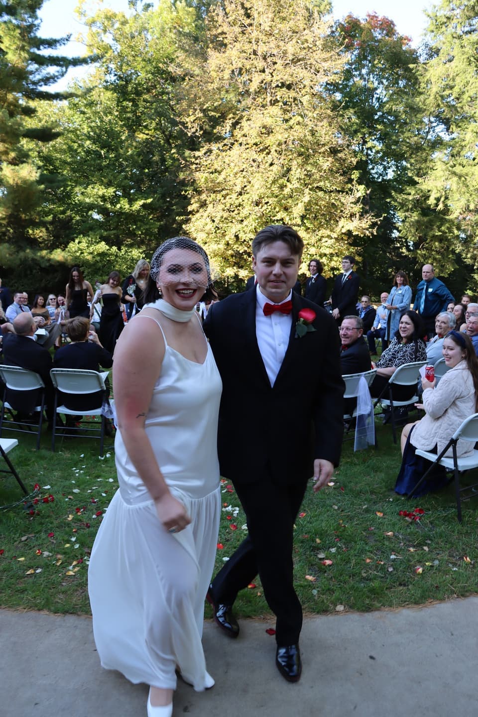 Abbi and Fred walk back up the aisle together, smiling, as newlyweds