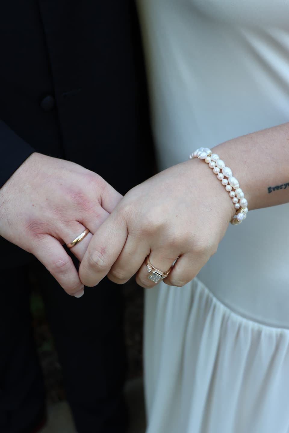 Close-up of Abbi's and Fred's hands showing their wedding rings